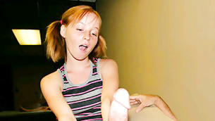 Sweetie whore with pony tails is giving this huge looking dick a rocky abusing hand job