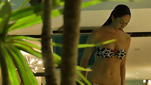 Some creepy fellow is spying on this outrageous bimbo taking off her swim suit